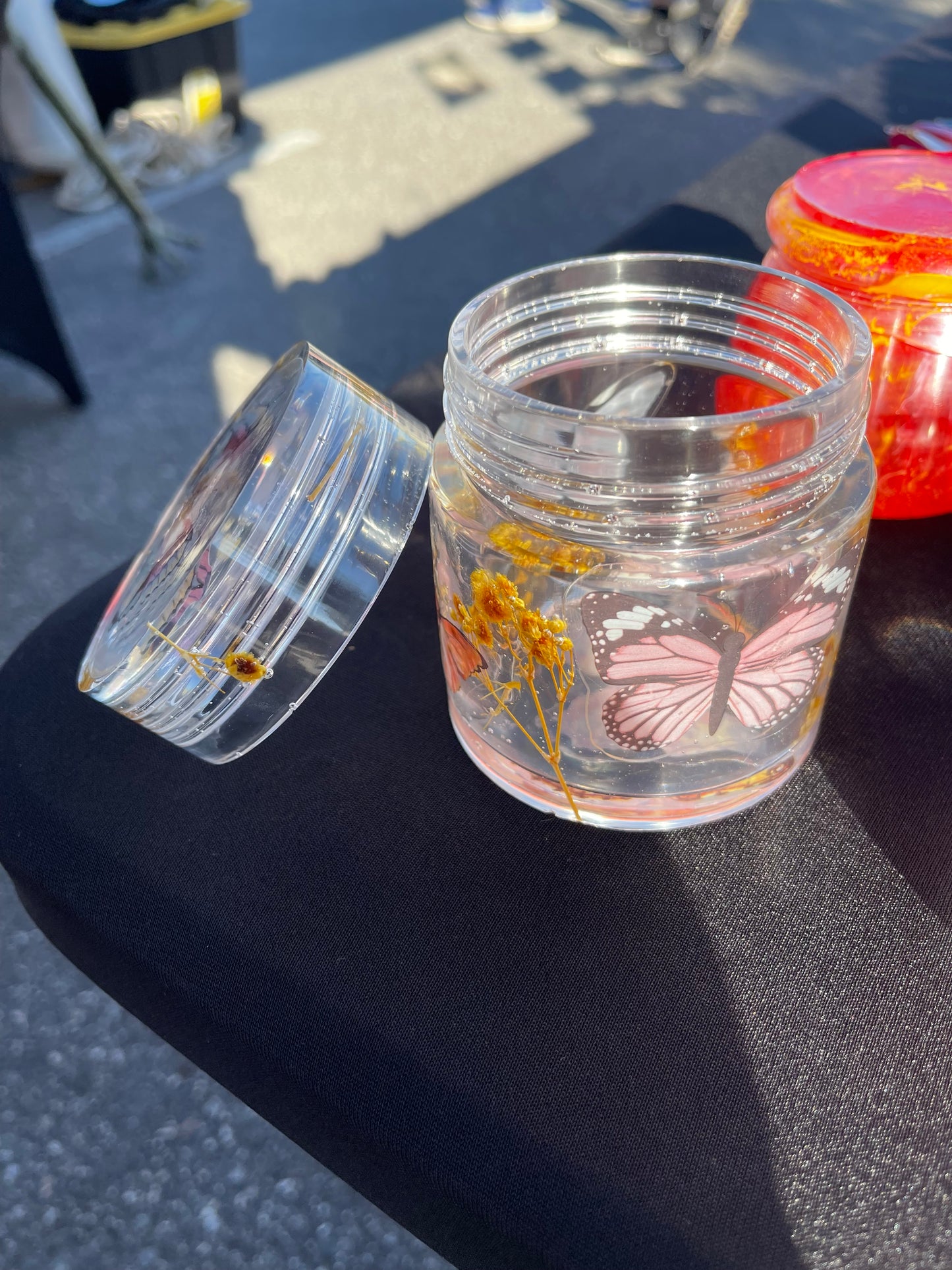 Cylinder jars with lids that screw on various designs and colors