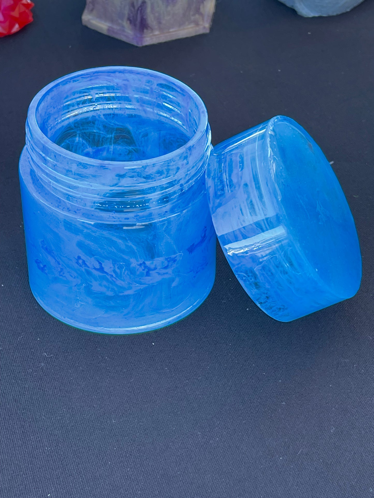 Cylinder jars with lids that screw on various designs and colors