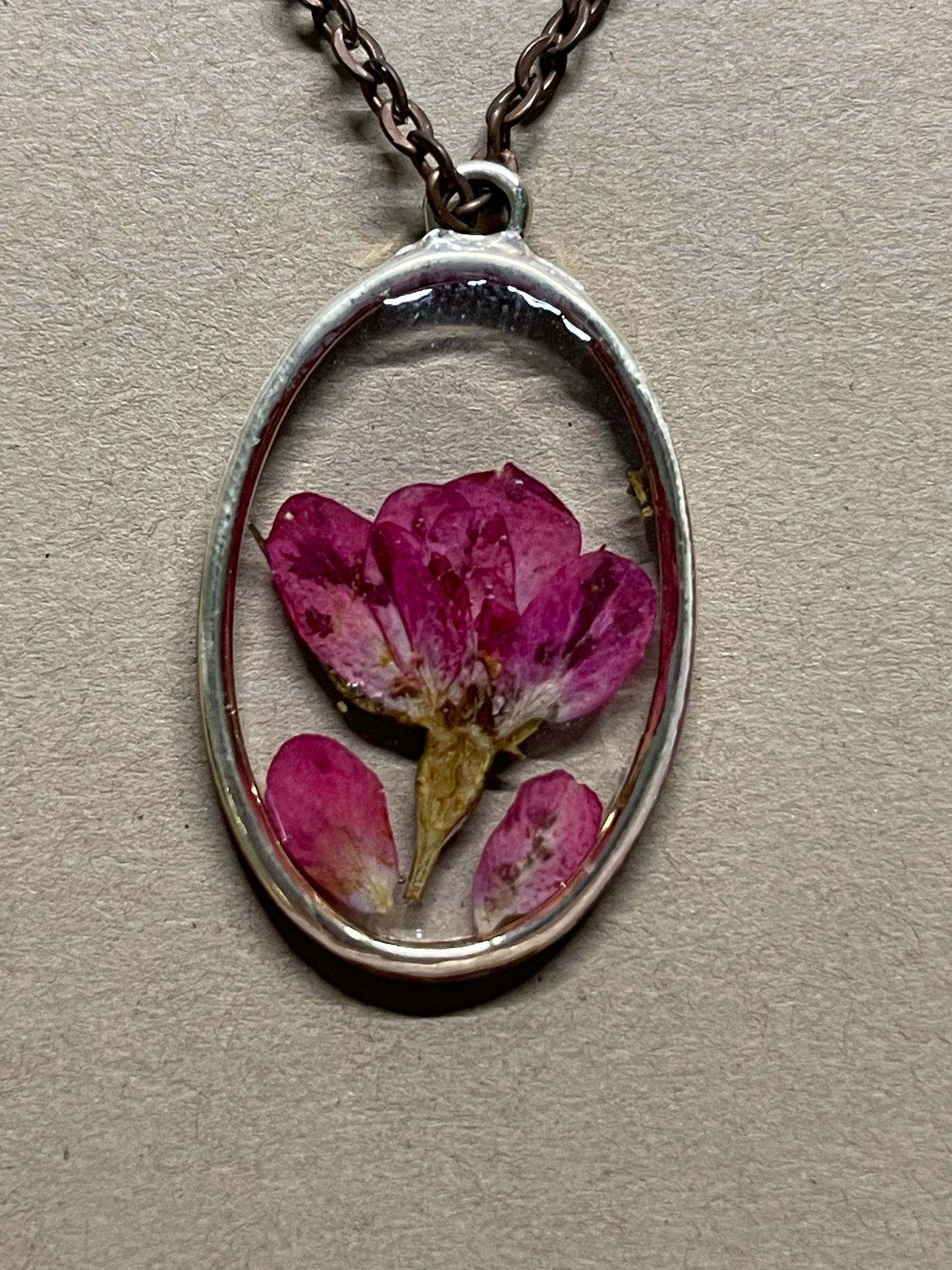 Lovely delicate peace beautiful red flower preserved in resin hanging from an 18 inch chain